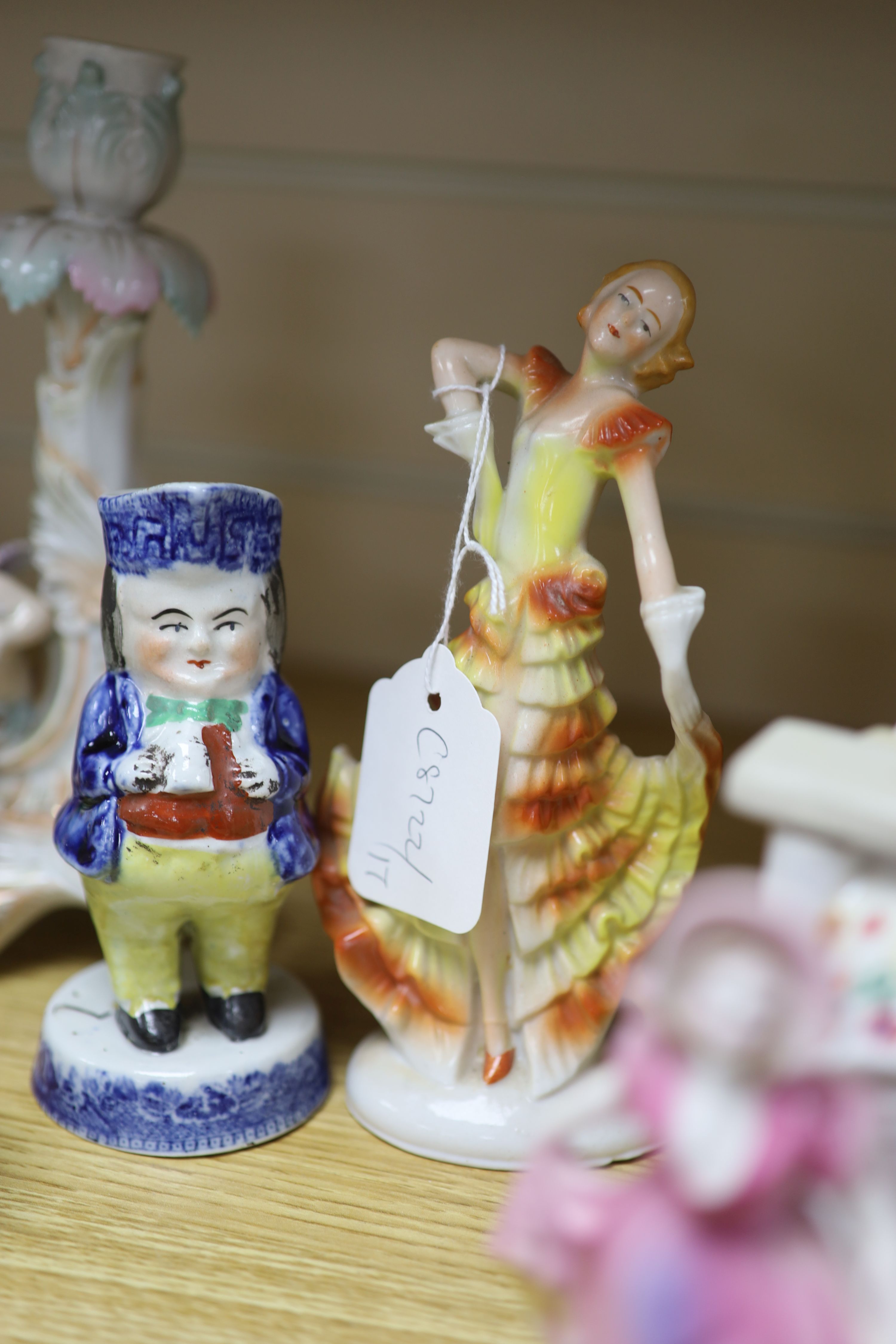 A collection of Art Deco ceramic dancing ladies, a 19th century figural box, a candlestick and a Toby jug, etc., tallest 22cm